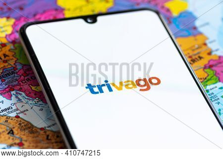 Vilnius, Lithuania - March 2 2020: Close up view of Trivago travel agency app, icons, logo displayed on a smartphone with a geographic map on background