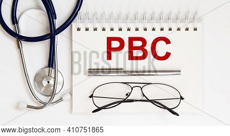 Stethoscope,glasses And Pen With Notepad With Text Pbc, Medicine