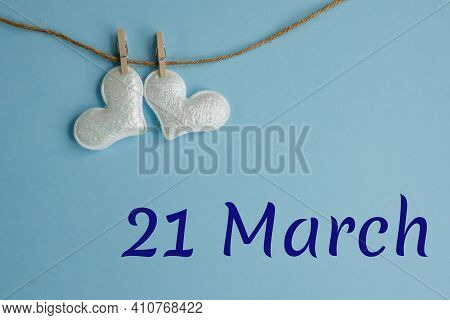 Commemorative Date Of March 21 On A Blue Background With White Hearts With Clothespins, Flat Lay. Ho
