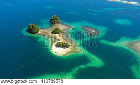 Island With A Sandy Beach And Azure Water Surrounded By A Coral Reef And An Atoll. Britania Islands,