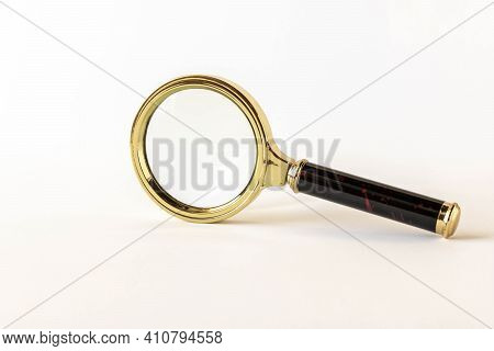 Magnifying Glass On A Light Background. The Concept Of Information Search. Selective Focus