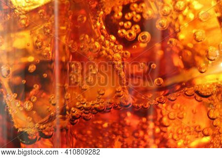 Macro Drink Kvass Coca-cola With Ice Close-up Bubbles In Drink Soda On A Dark Black Background