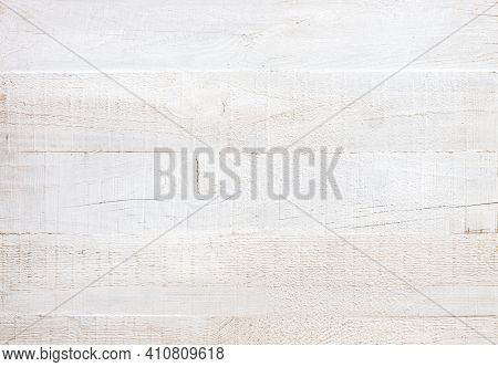 Uncouth wooden board painted white. Grunge background. Old wooden shabby texture. Flat lay.