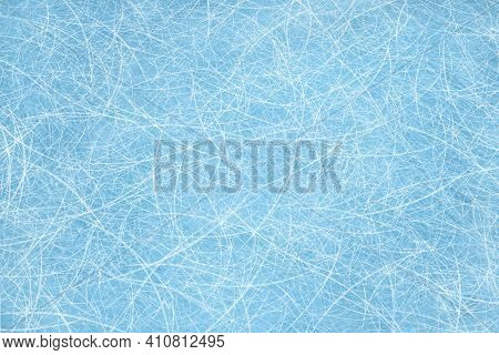 Ice Blue Background With Ice Skating Tracks. Frozen Water, Sea. Frosty Ice Texture With Winter Graph