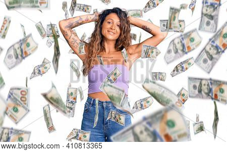 Young hispanic woman with tattoo wearing casual clothes relaxing and stretching, arms and hands behind head and neck smiling happy