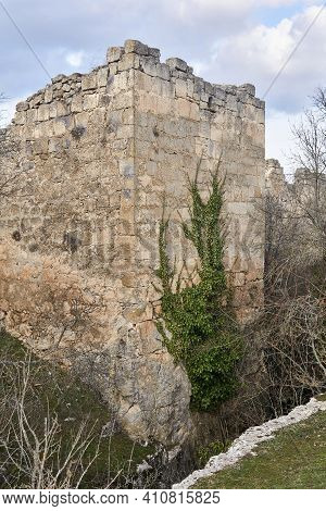 Dilapidated Medieval Fortress Tower, Entwined With Ivy