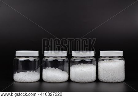 Transparent Bottle Inside With Plastic Beads. White Polymer. White Plastic Beads.