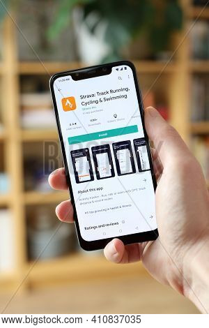 Warsaw, Poland - January 29, 2021: User Installing Strava Fitness Tracking And Running App On An And