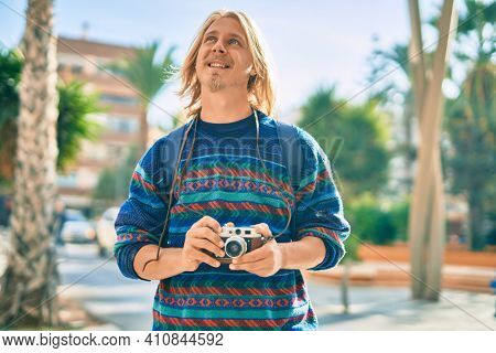 Young scandinavian tourist man smiling happy at the city.
