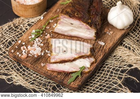 A Piece Of Baked Meat With Layers Of Bacon, Cut From The Bottom Of A Pork Carcass, Along With The Sk