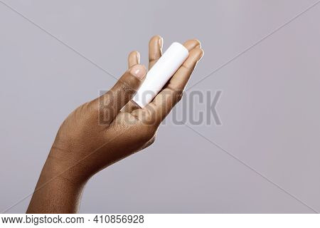 Lip Care Products. Moisturising Chapstick In Hand Of Unrecognizable African American Woman Isolated 