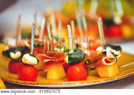 Buffet At The Reception. Glasses Of Wine And Champagne. Assortment Of Canapes On A Wooden Board. Ban