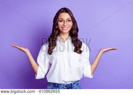 Photo Of Promoter Lady Hands Hold Empty Spaces Beaming Smile Wear Glasses White Shirt Isolated Purpl
