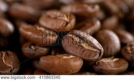 Falling Roasted Coffee Beans, Macro Shot, close-up.