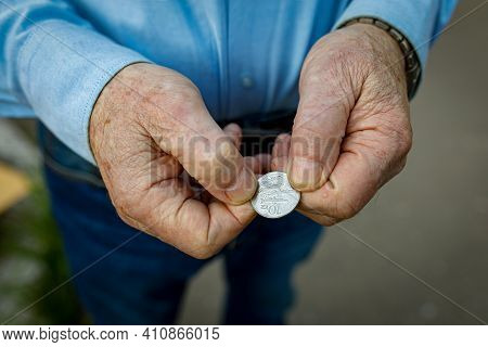 10 Isk In The Hands Of An Elderly Man. Icelandic Coin In The Calloused Hands Of A Fisherman. Money S