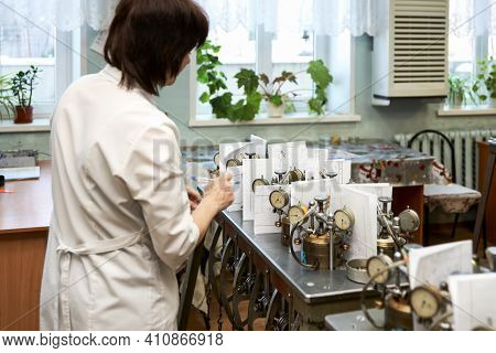 Laboratory Of Soil Mechanics. The Laboratory Assistant Takes Readings From Compression Devices. Sele
