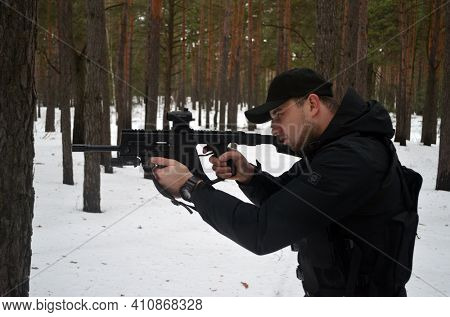 Man with KRISS Vector 9*21 caliber submachine gun in the winter forest. Unformal shooting range near Kiev.February 27, 2021. Kiev Region, Ukraine