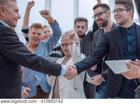 Businessteam is introducing a colleague to another businessman