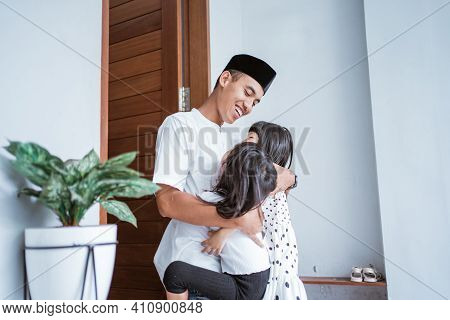 Excited Father Hug And Embrace His Children During Eid Mubarak Celebration