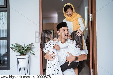 Excited Father Hug And Embrace His Children During Eid Mubarak Celebration