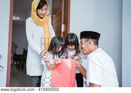 Muslim Father Giving A Gift To His Children On Eid Mubarak