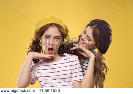 Mom And Daughter Embrace Joy Fun Childhood Lifestyle Yellow Background