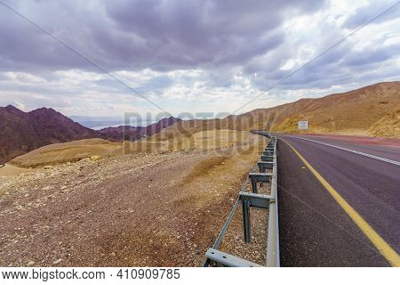 View Of Desert Road 12, With A Trilingual Warning Sign (dangerous Curves) And Landscape. Eilat Mount