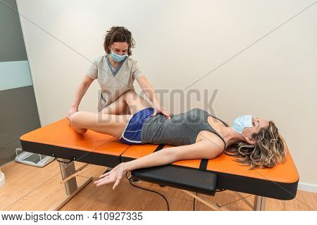 Physiotherapist And Patient In Global Postural Re-education Session, With Pandemic Protection Mask.