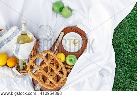 Breakfast At Sunrise, On The Grass White Sheet With A Tray With Cheese And Vine, Dry Bread, Apple, L