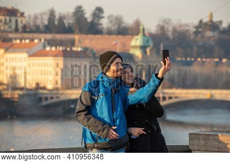 Prague, Czech Republic. 03-02-2021. Tourist Couple Taking A Selfie Or Self Portrait And Having Good 