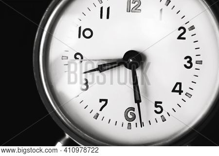 A Black-and-white Image Of The Dial Of An Old Clock That Shows Half Past Eight In The Morning. The C