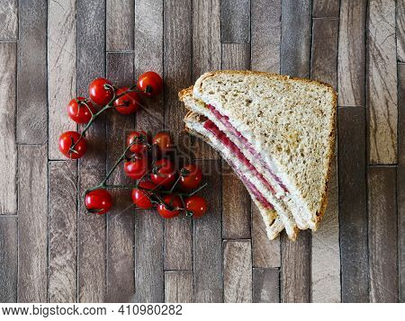 Whole-meal bread sandwich topped with Lyon rosette and butter