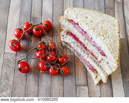 Whole-meal bread sandwich topped with Lyon rosette and butter