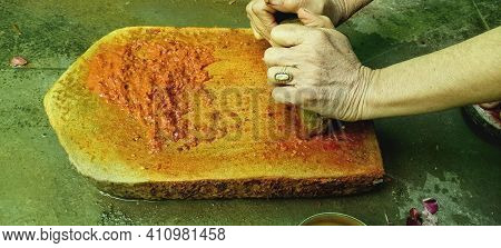 Traditional Grinding Whole Spices On Grindstone In India