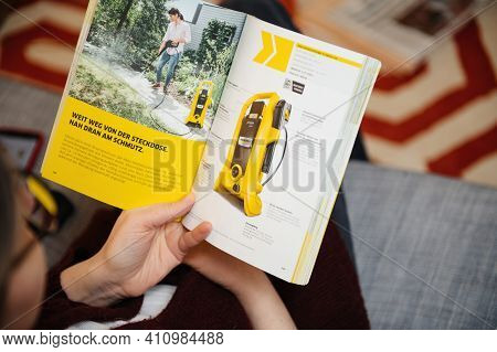 Paris, France - Mar 2, 2021: Curious Woman Reading Latest Advertising Catalogue Of Karcher German Fa