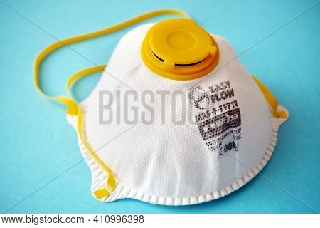 White Ffp1 Respirator On A Blue Background. Dust Protection Respirator Or Medical Respiratory Mask A