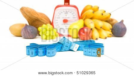 Measuring Tape, Kitchen Scale And Vegetables On A White Background