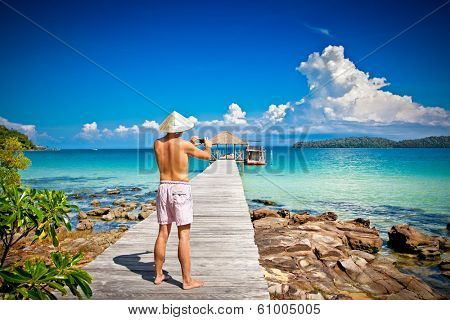 Man on a tropical beach at Koh Rong Samloem island  in Cambodia.