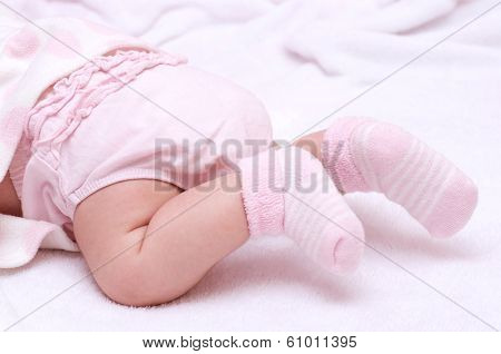 Newborn baby girl feet in pink socks