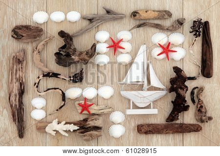 Sea shell and driftwood abstract design with red starfish over old oak background.