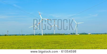 Wind Energy Wowers Standing In The Field In Spring