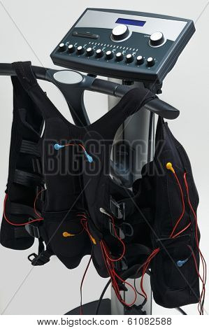 Training suit hanging on Modern Electro Muscular Stimulation EMS machine 