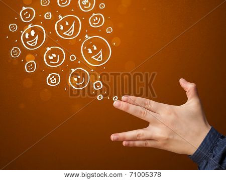Group of happy hand drawed smiley faces coming out of gun shaped hands