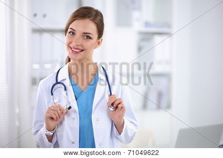 Portrait of happy successful young female doctor holding a stet