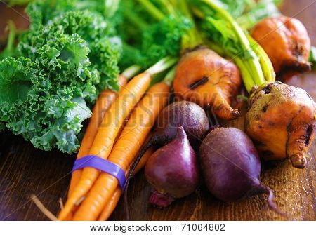 pile of veggies with carrots, beets and kale