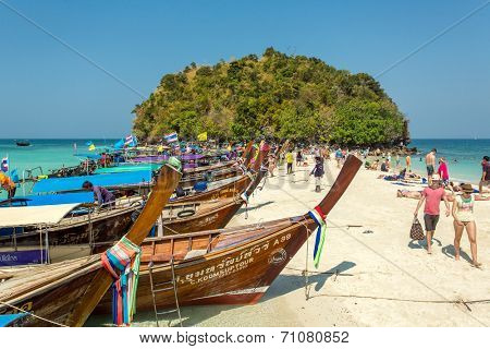 KOH MOR ISLAND, KRABI, THAILAND - FEBRUARY 19, 2014: Tourists and traditional Thai long-tail boats on the small Koh Mor island near Krabi, Thailand on 19 February, 2014.
