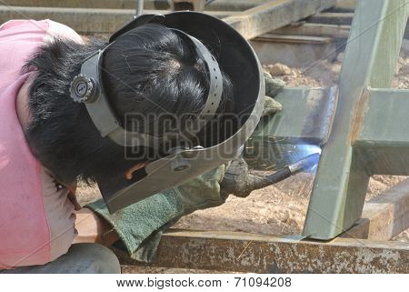 Welder with protective mask welding metal