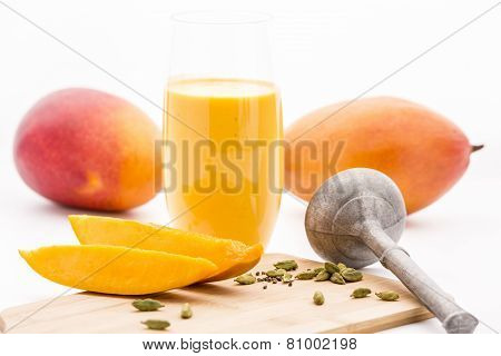 Crushed Cardamon, Pestle, Mangos And Mango Lassie