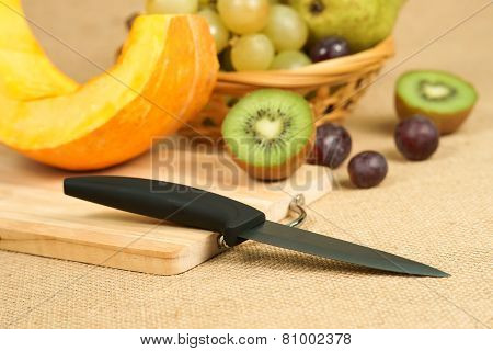 Mix of fruits with cutting board and knife