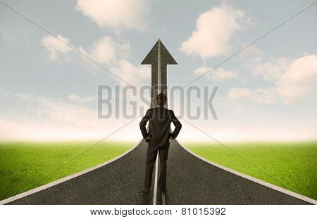Businessman lokking at 3d road upgoing arrow concept